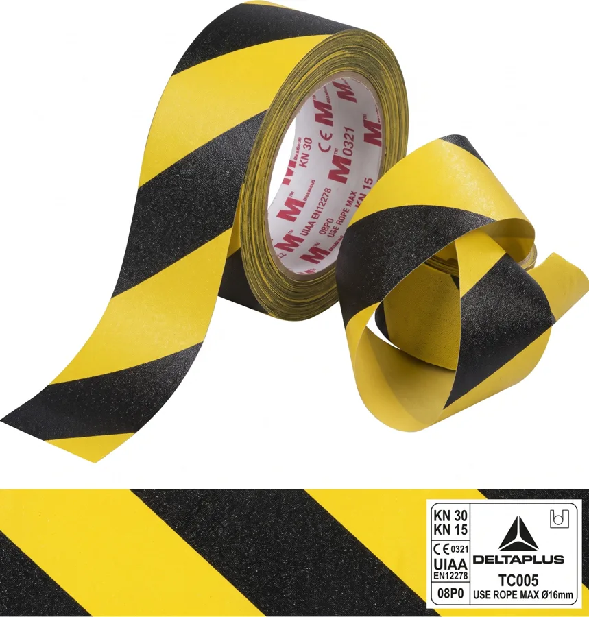 Rollos de cinta antideslizante con franjas diagonales amarillas y negras sobre fondo blanco